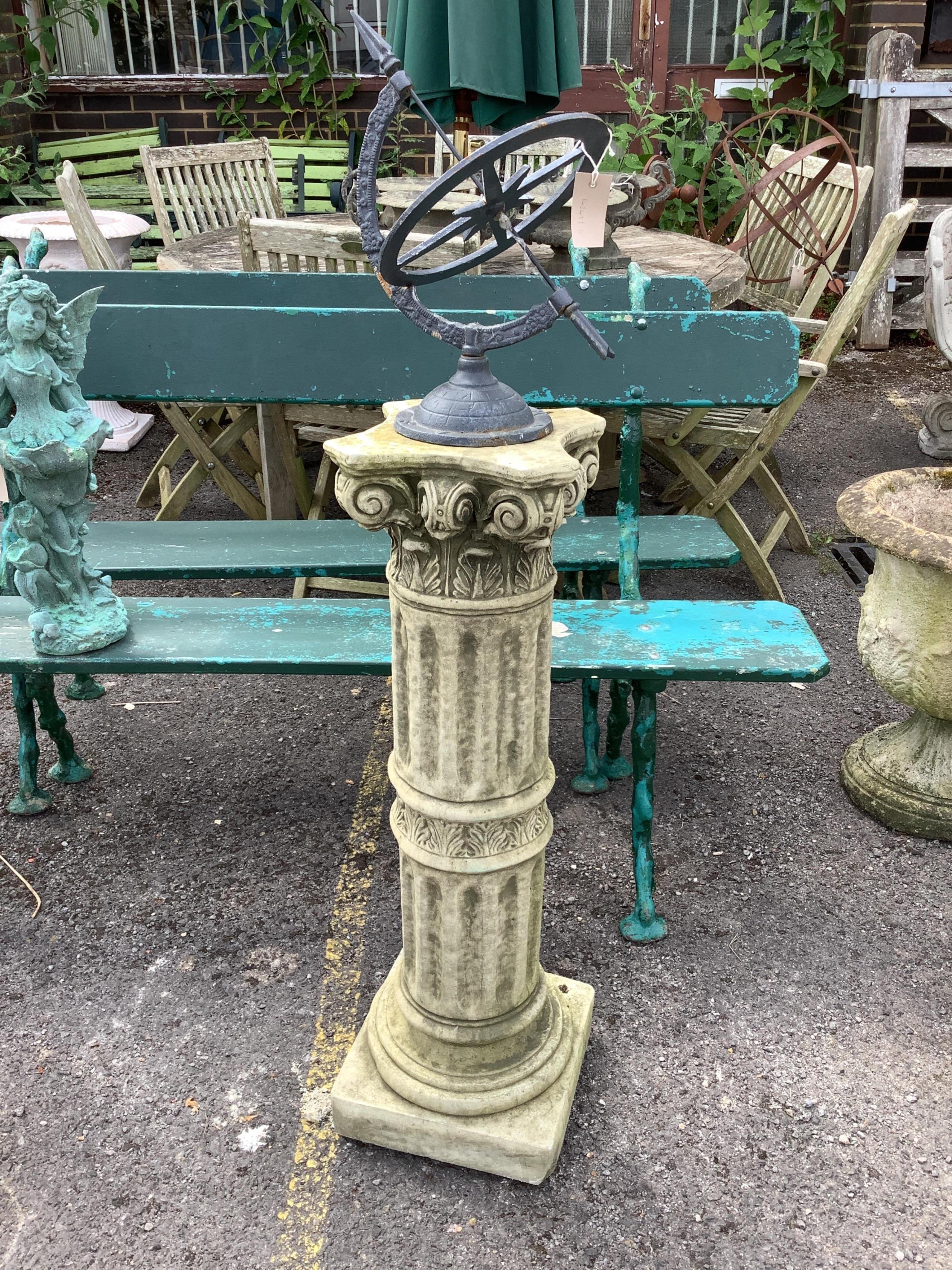 An armillary sphere on a reconstituted stone column. Condition - good